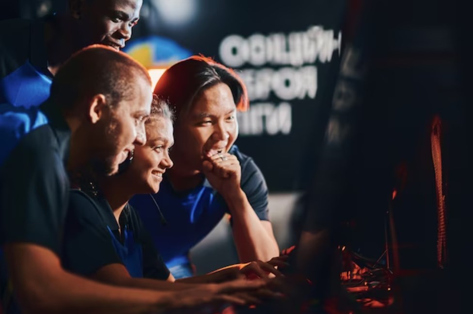 a team of happy professional game developers looking at a PC screen and feeling excited